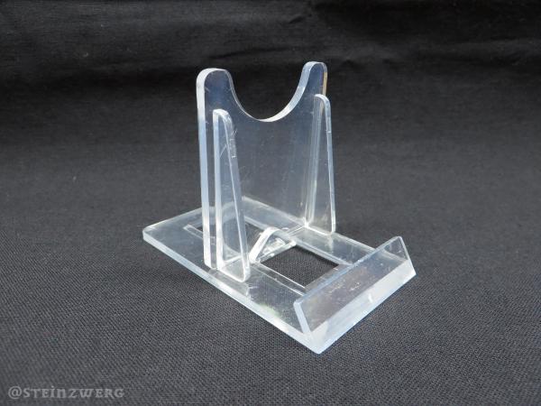 Verstellbarer Schiebeständer aus transparentem Kunststoff.